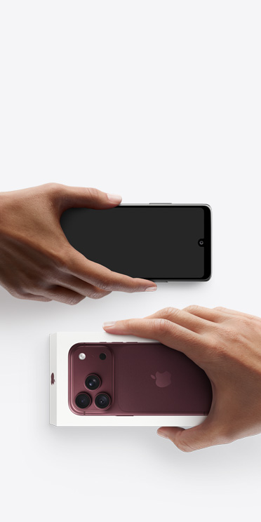 Dos manos intercambian teléfonos: un Android sin caja a la izquierda y un nuevo iPhone 18 Pro, color borgoña (rojo oscuro), en su caja, a la derecha