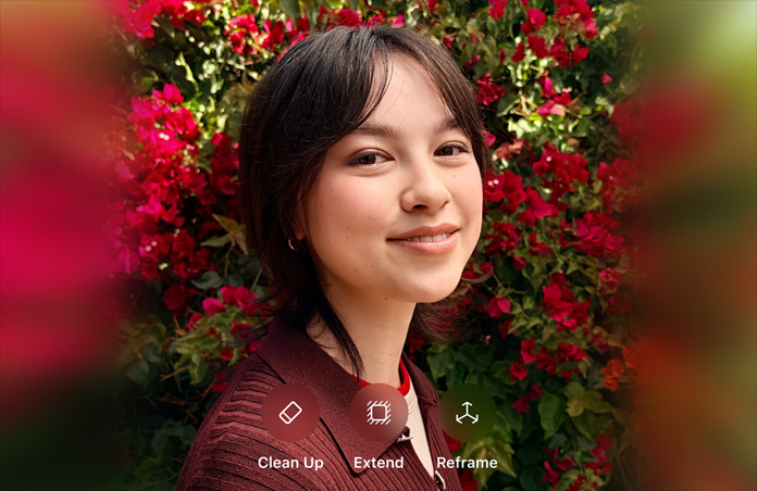 Foto de una persona sonriente de pelo castaño, vistiendo un suéter café, rodeada de flores rojas, demostración de edición de fotos con IA con las opciones Borrador, Ampliar y Reencuadrar en la foto